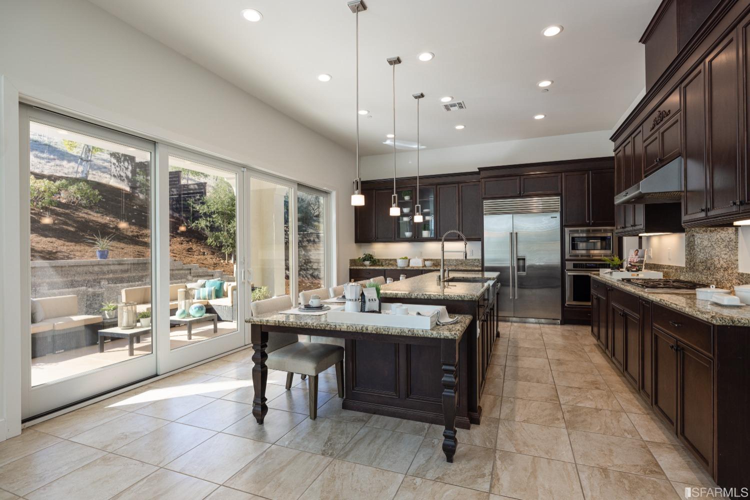 30 Wilder Road Orinda, CA 94563 - Photo 19 of 57 a kitchen with kitchen island granite countertop a large counter top space a sink stainless steel appliances and cabinets