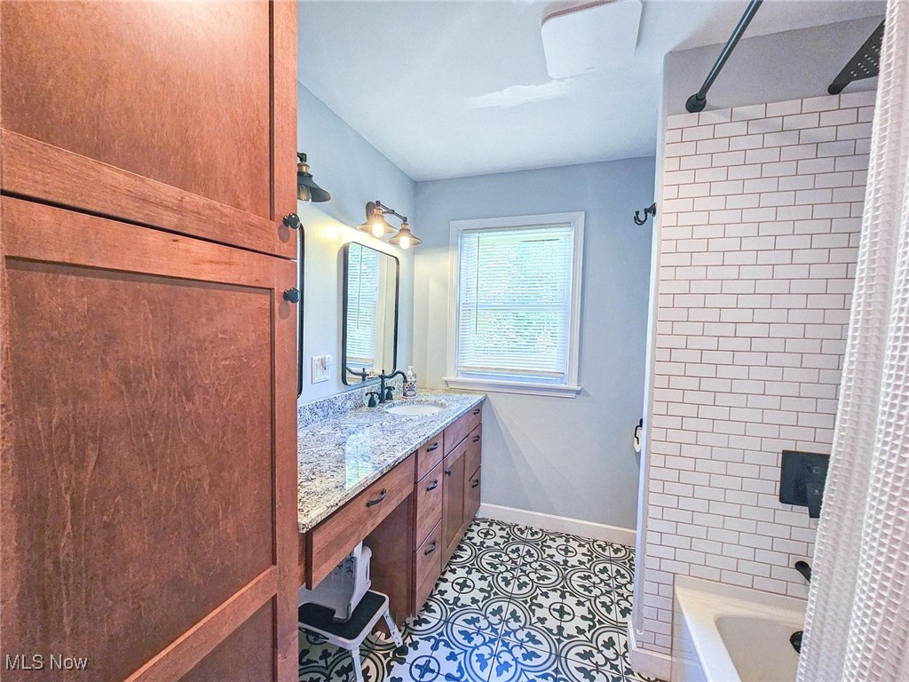 4270 Mellinger Road Canfield, OH 44406 - Photo 28 of 49 Full bathroom with shower / tub combo with curtain, vanity, and light tile patterned floors