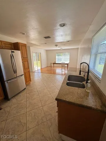 a kitchen with stainless steel appliances granite countertop a sink a stove a refrigerator and cabinets