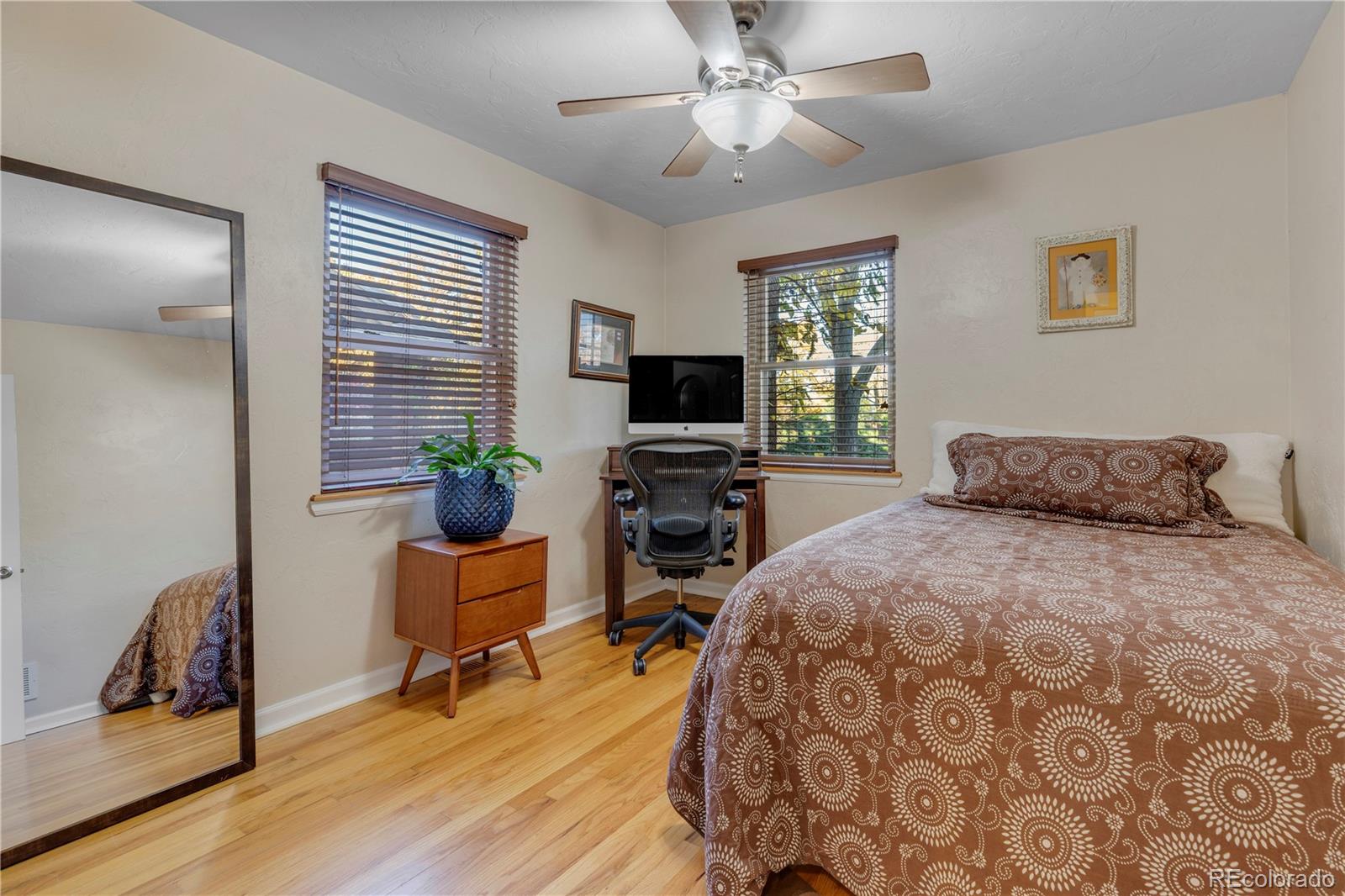 2651 Adams Street Denver, CO 80205 - Photo 13 of 37 a bedroom with a bed and wooden floor