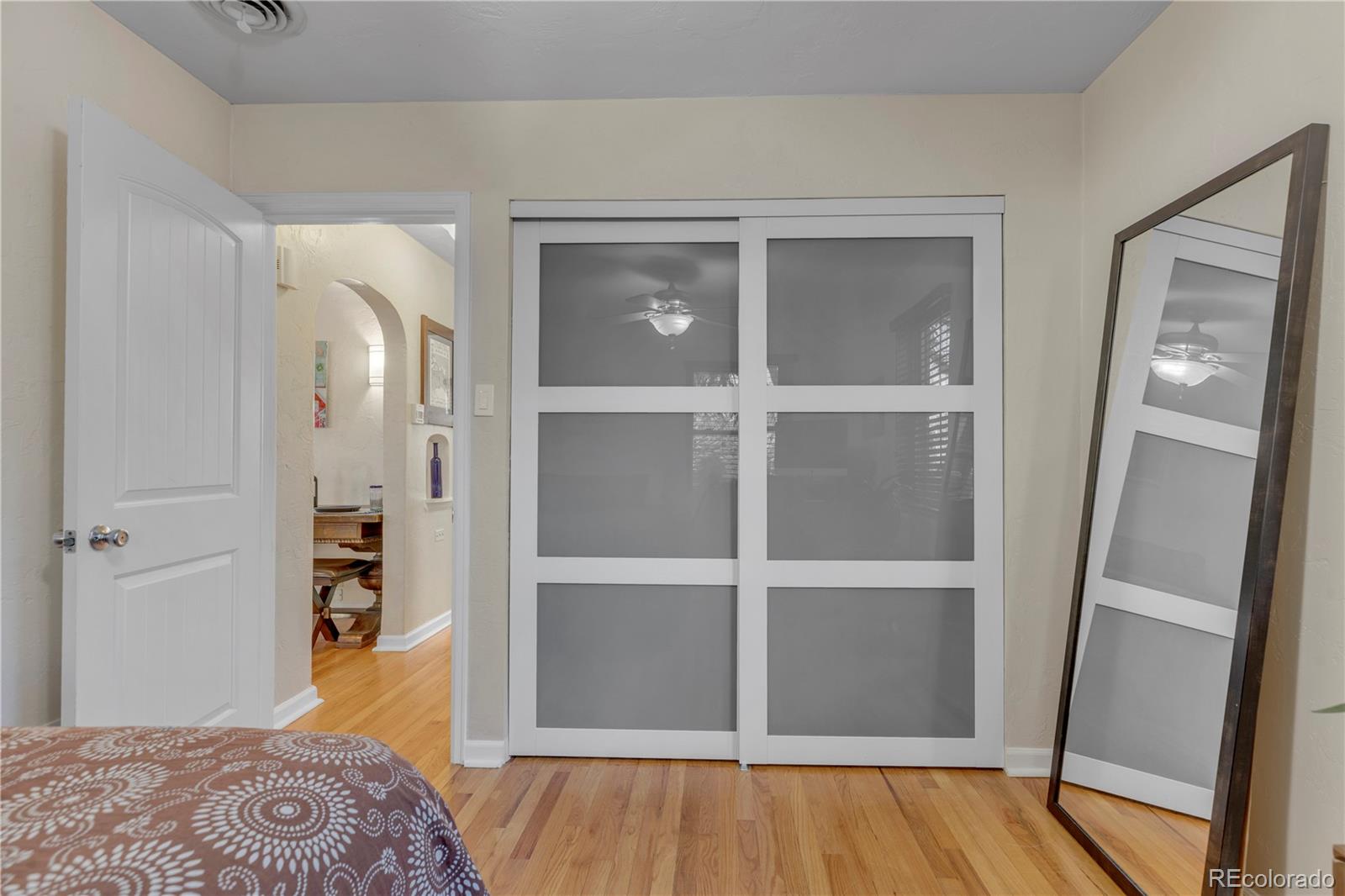 2651 Adams Street Denver, CO 80205 - Photo 14 of 37 a view of walk in closet with wooden floor and closet