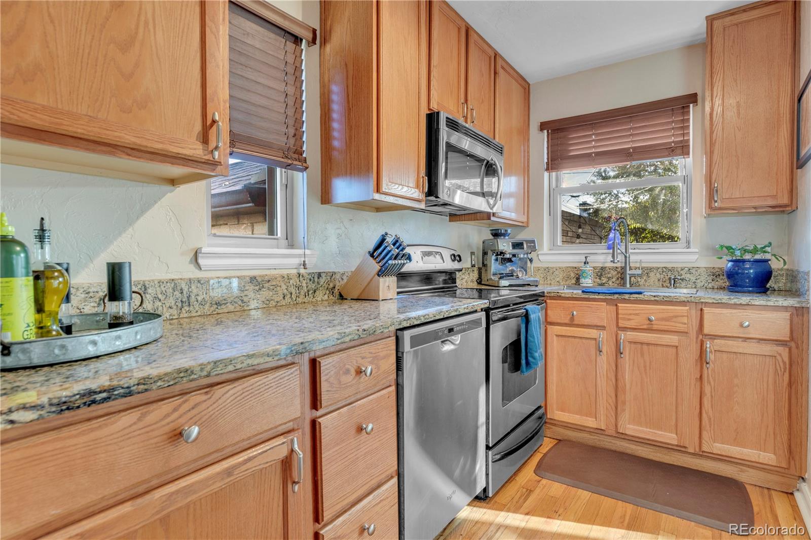 2651 Adams Street Denver, CO 80205 - Photo 16 of 37 a kitchen with granite countertop stainless steel appliances a sink window and cabinets