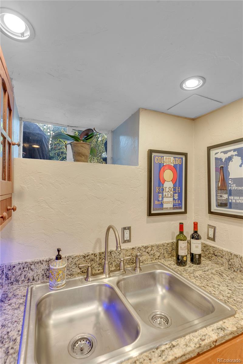 2651 Adams Street Denver, CO 80205 - Photo 22 of 37 a bathroom with a sink mirror vanity and bathtub