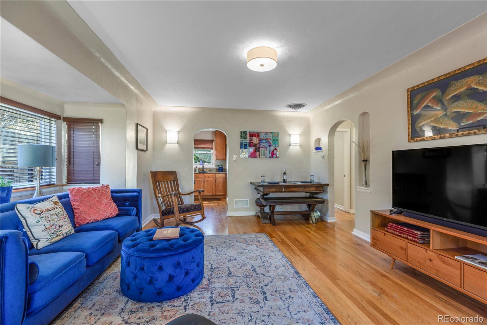 2651 Adams Street Denver, CO 80205 - Photo 8 of 37 a living room with furniture and a flat screen tv