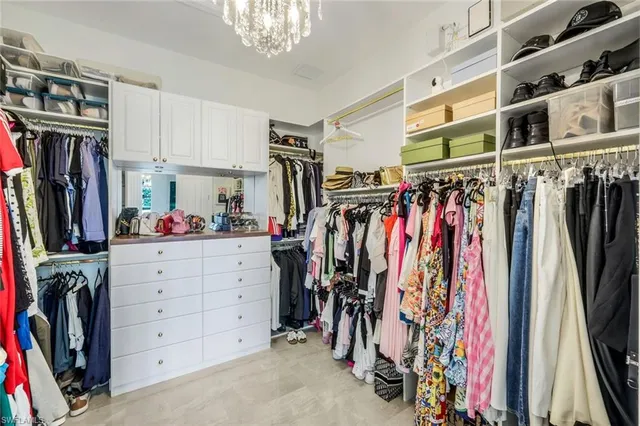 a bedroom with furniture and a chandelier