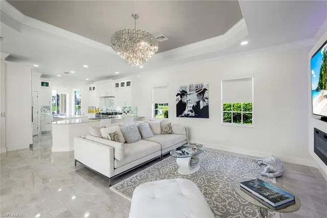a living room with furniture and a chandelier