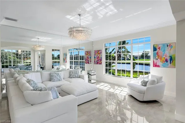 a living room with furniture and a chandelier