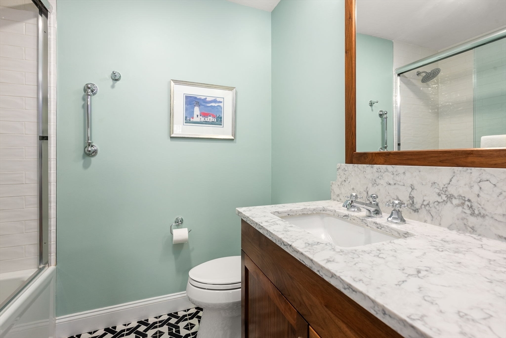 5 Upham Way, Unit 5 Weston, MA 02493 - Photo 22 of 29 a bathroom with a granite countertop sink a toilet and a mirror