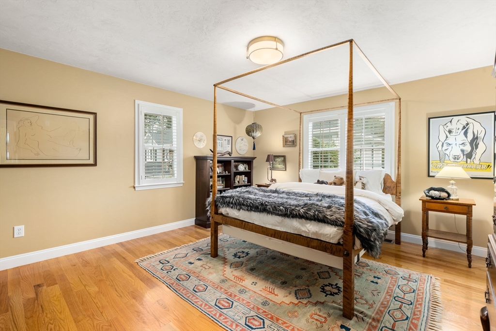 5 Upham Way, Unit 5 Weston, MA 02493 - Photo 23 of 29 a bedroom with a bed and wooden floor