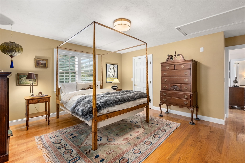 5 Upham Way, Unit 5 Weston, MA 02493 - Photo 24 of 29 a bedroom with a bed a table and chair