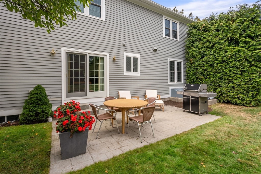 5 Upham Way, Unit 5 Weston, MA 02493 - Photo 28 of 29 a backyard of a house with table and chairs