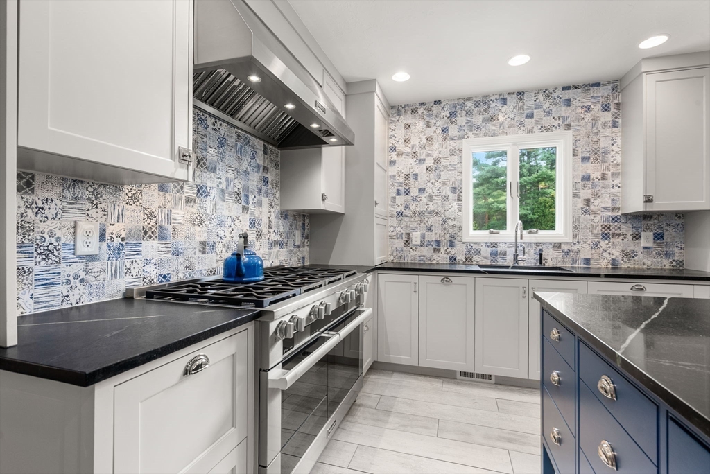 5 Upham Way, Unit 5 Weston, MA 02493 - Photo 6 of 29 a kitchen with stainless steel appliances granite countertop a sink stove and cabinets