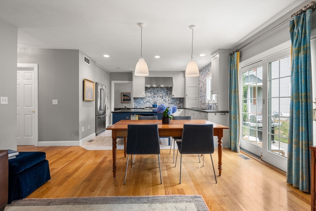 5 Upham Way, Unit 5 Weston, MA 02493 - Photo 10 of 29 a dining room with wooden floor a glass table and chairs