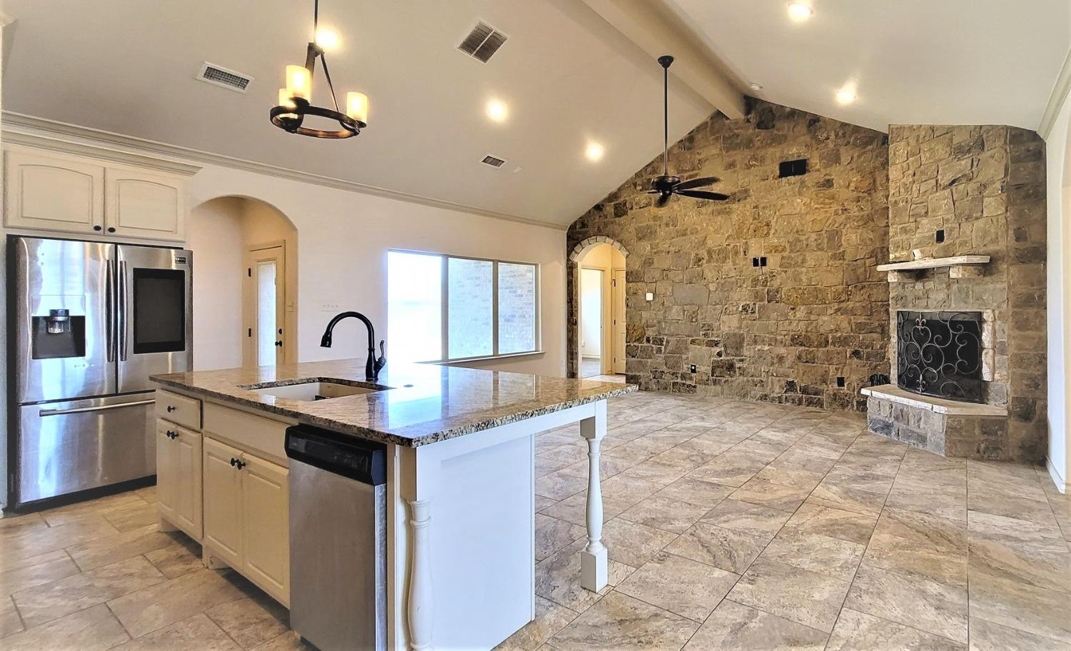 5234 Kemper Street Lubbock, TX 79416 - Photo 7 of 28 a large kitchen with stainless steel appliances granite countertop a sink stove and refrigerator