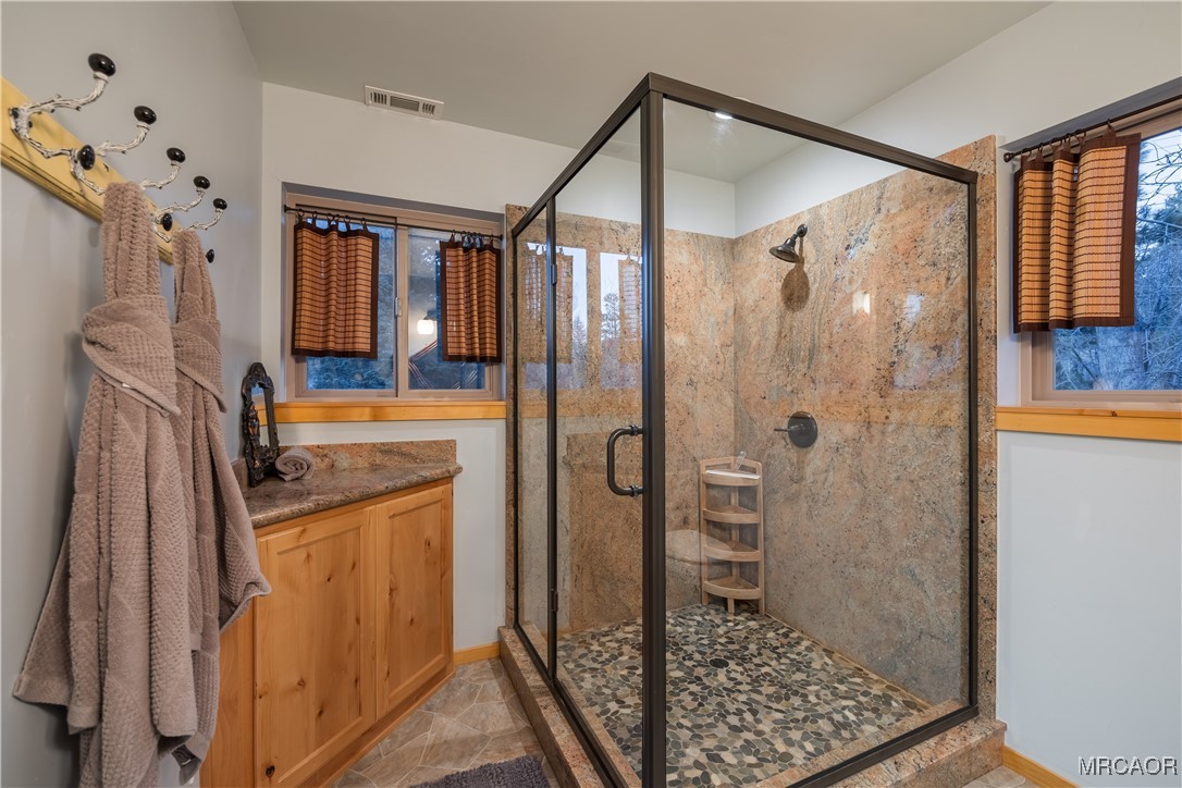 448 Edgemoor Road Big Bear Lake, CA 92315 - Photo 29 of 42 a bathroom with a granite countertop shower a mirror and a sink
