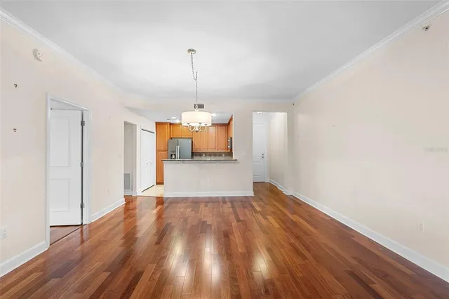 a view of empty room with wooden floor