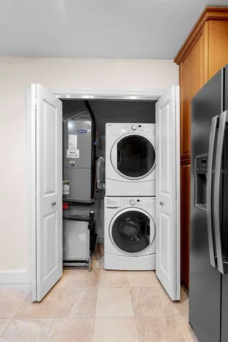 a view of a kitchen with a sink and a refrigerator