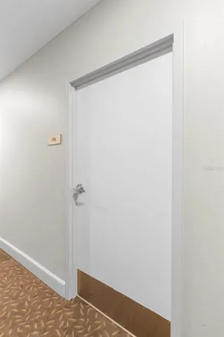 a view of a room with wooden floor