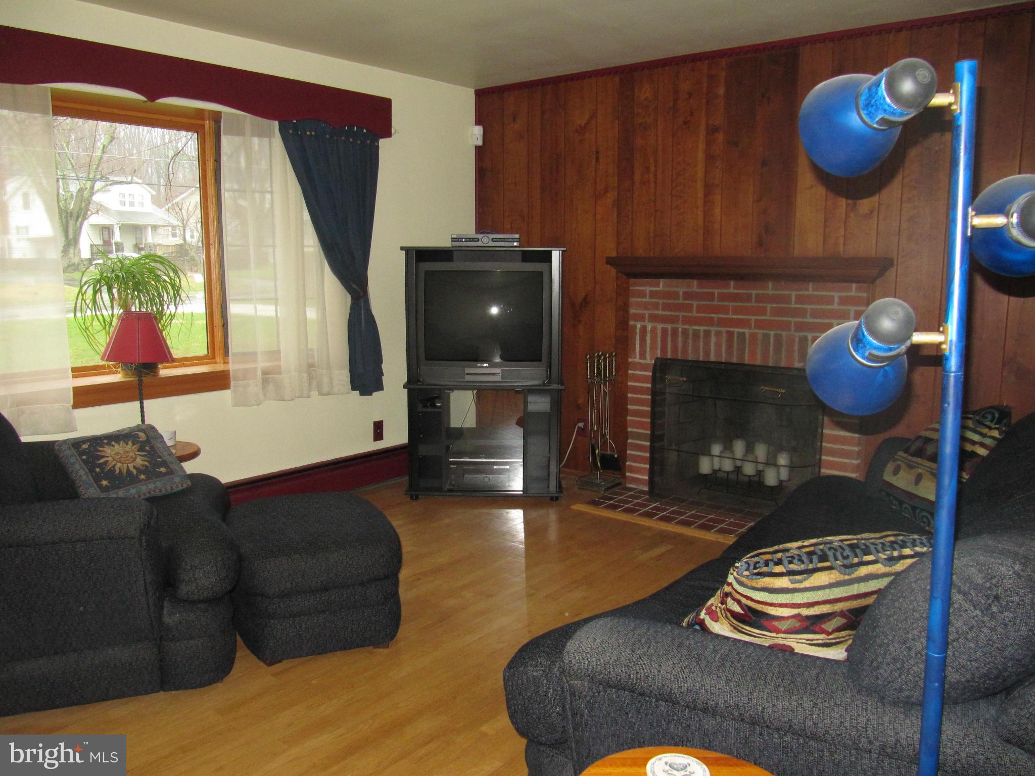 7518 Windsor Mill Road Baltimore, MD 21244 - Photo 2 of 17 a living room with furniture and a fireplace