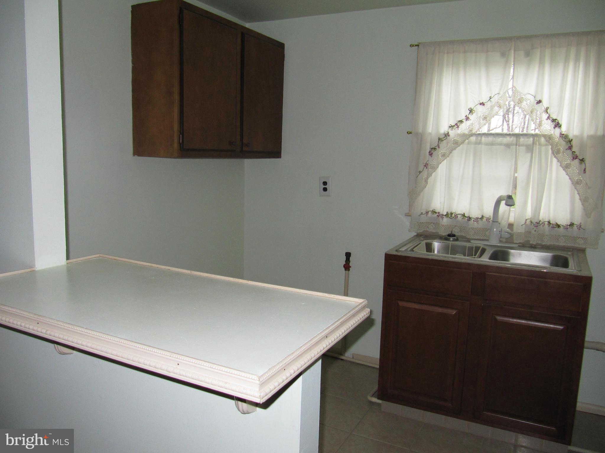 7518 Windsor Mill Road Baltimore, MD 21244 - Photo 13 of 17 a room with a wooden floor and a sink