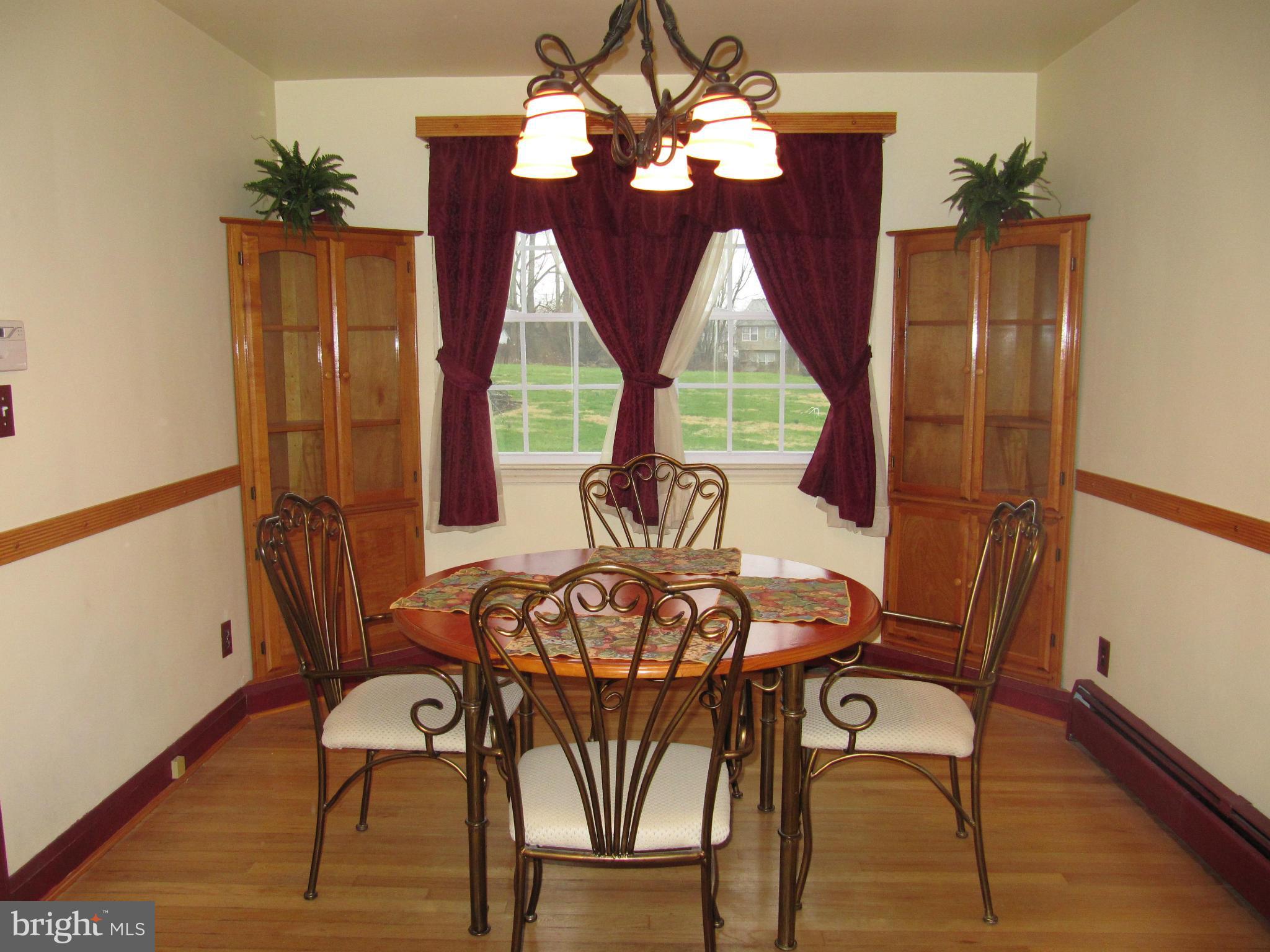 7518 Windsor Mill Road Baltimore, MD 21244 - Photo 3 of 17 a view of a dining room with furniture wooden floor and chandelier