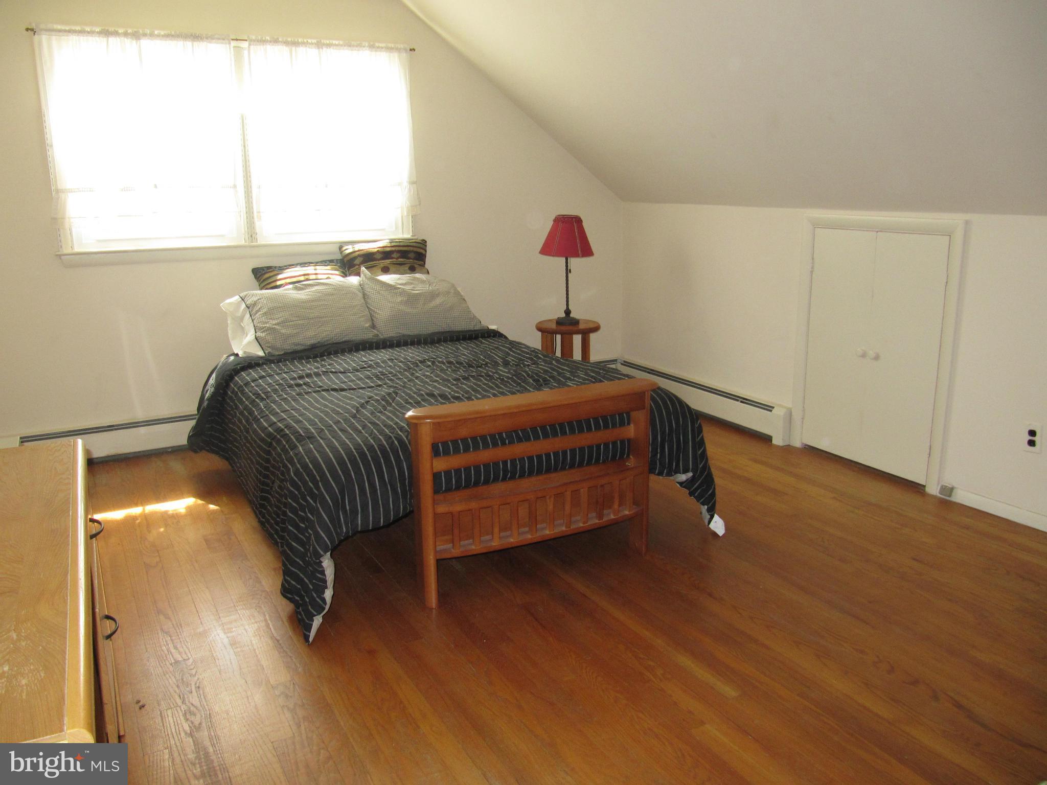 7518 Windsor Mill Road Baltimore, MD 21244 - Photo 7 of 17 a bedroom with a bed and a window