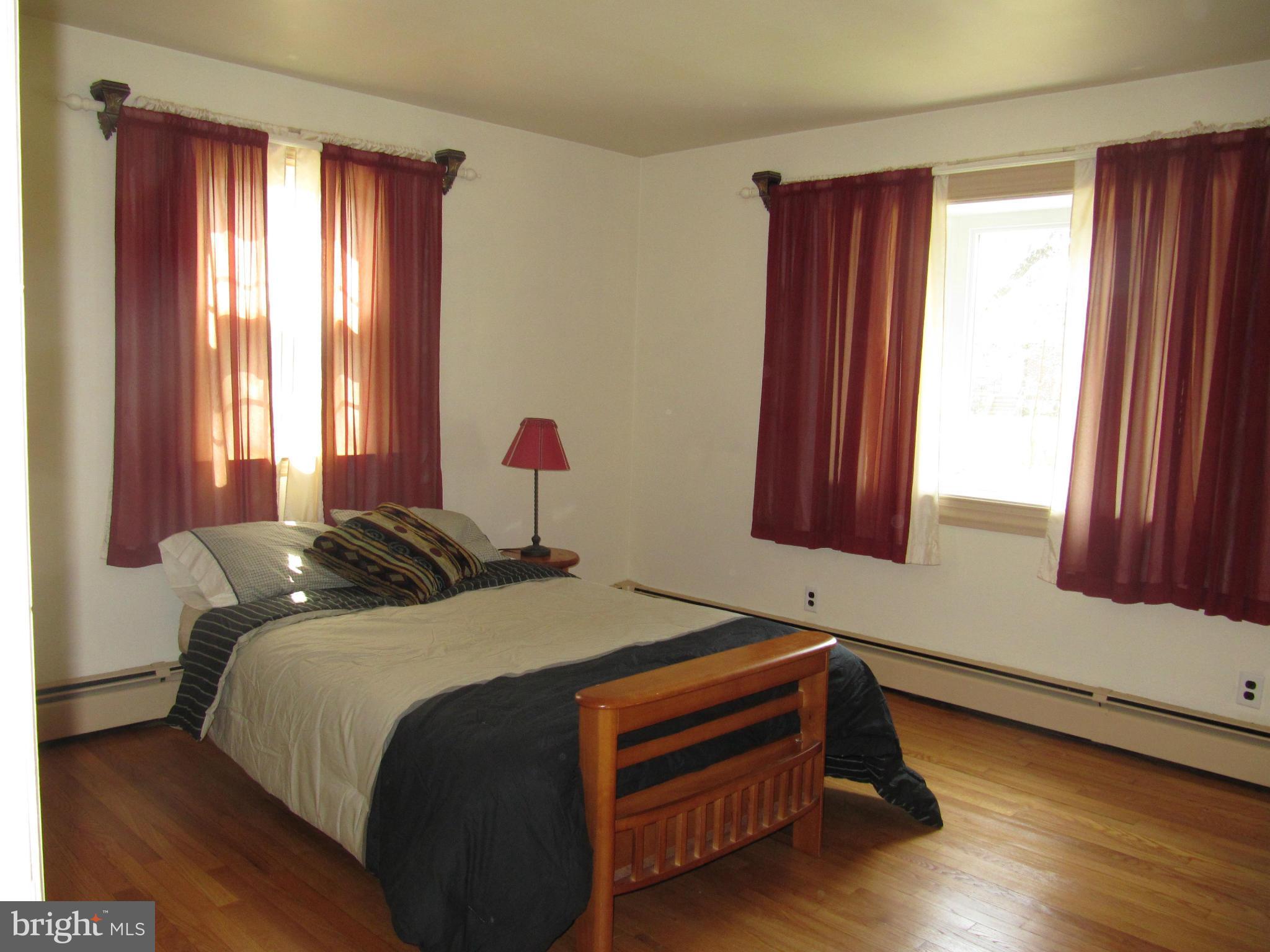 7518 Windsor Mill Road Baltimore, MD 21244 - Photo 10 of 17 a bed sitting in a bedroom next to a window