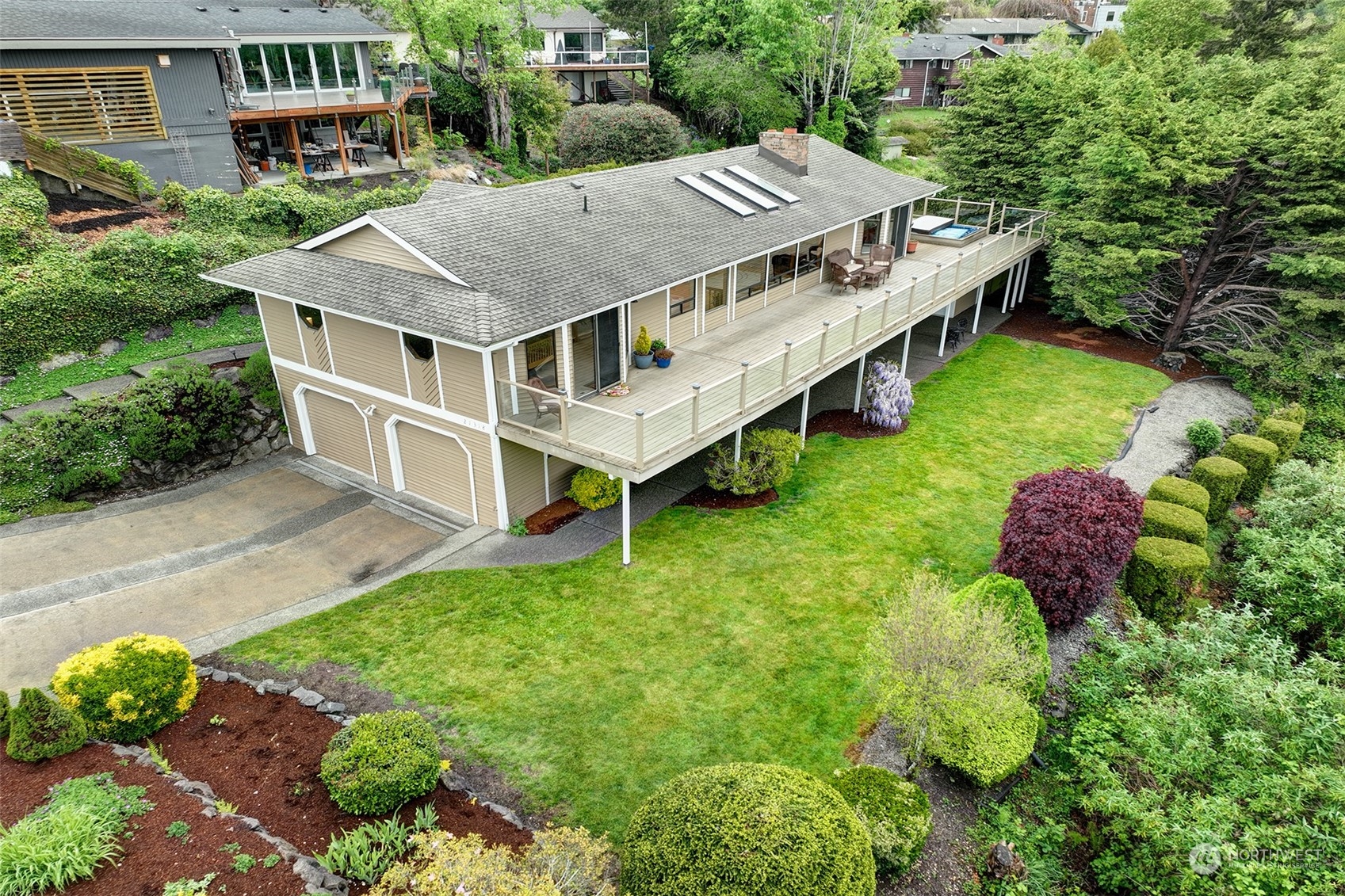 an aerial view of a house with yard and roof deck