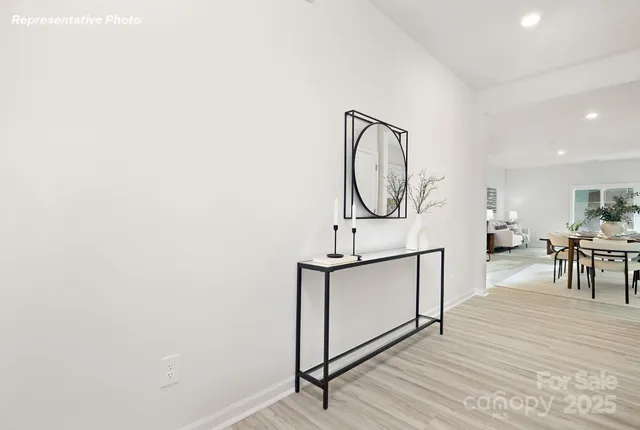 a view of a room with wooden floor and white walls