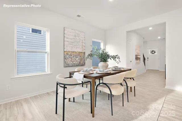 a view of a dining room with furniture and window