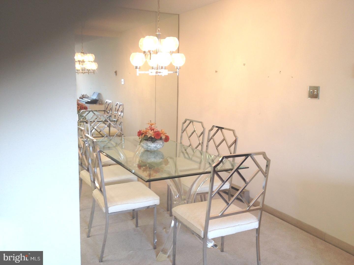 860 Lower Ferry Road, Unit 4F Ewing, NJ 08628 - Photo 1 of 18 a view of a dining room with furniture and chandelier