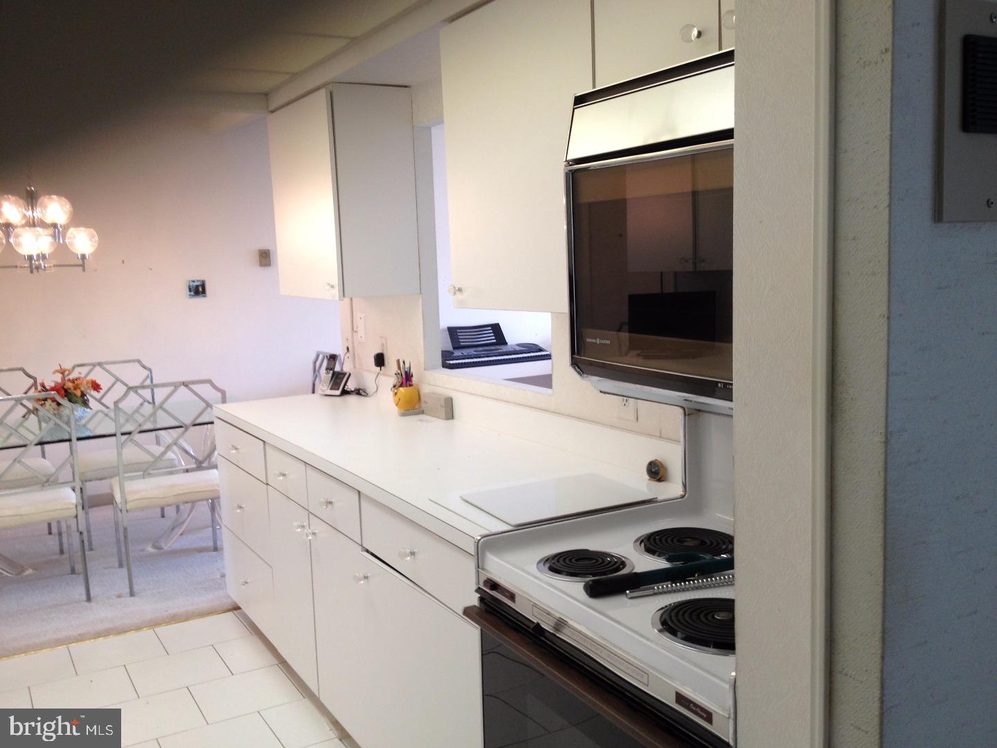 860 Lower Ferry Road, Unit 4F Ewing, NJ 08628 - Photo 2 of 18 a kitchen with a sink and a stove top oven with wooden floor