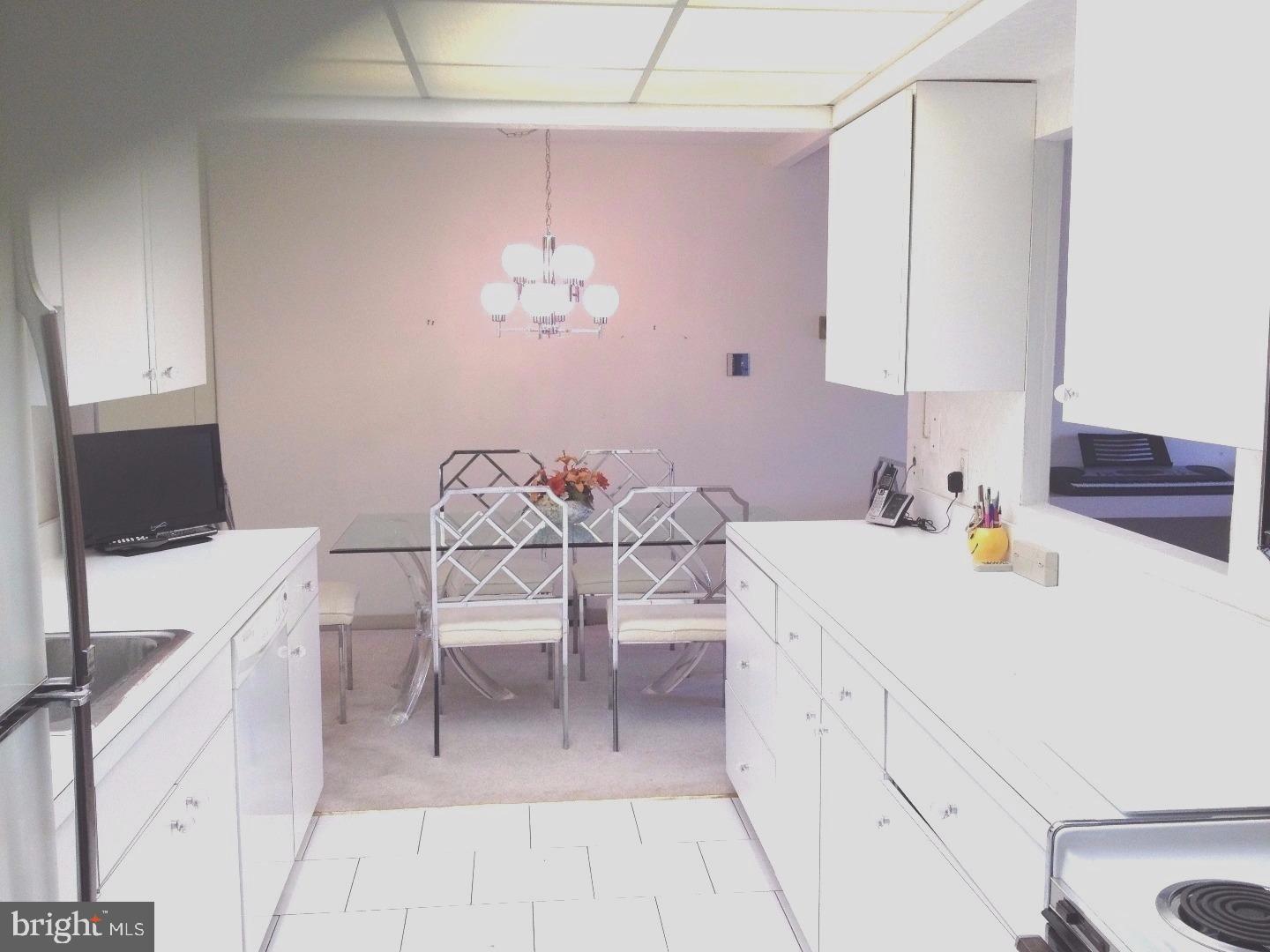 860 Lower Ferry Road, Unit 4F Ewing, NJ 08628 - Photo 3 of 18 a kitchen with a table and chairs