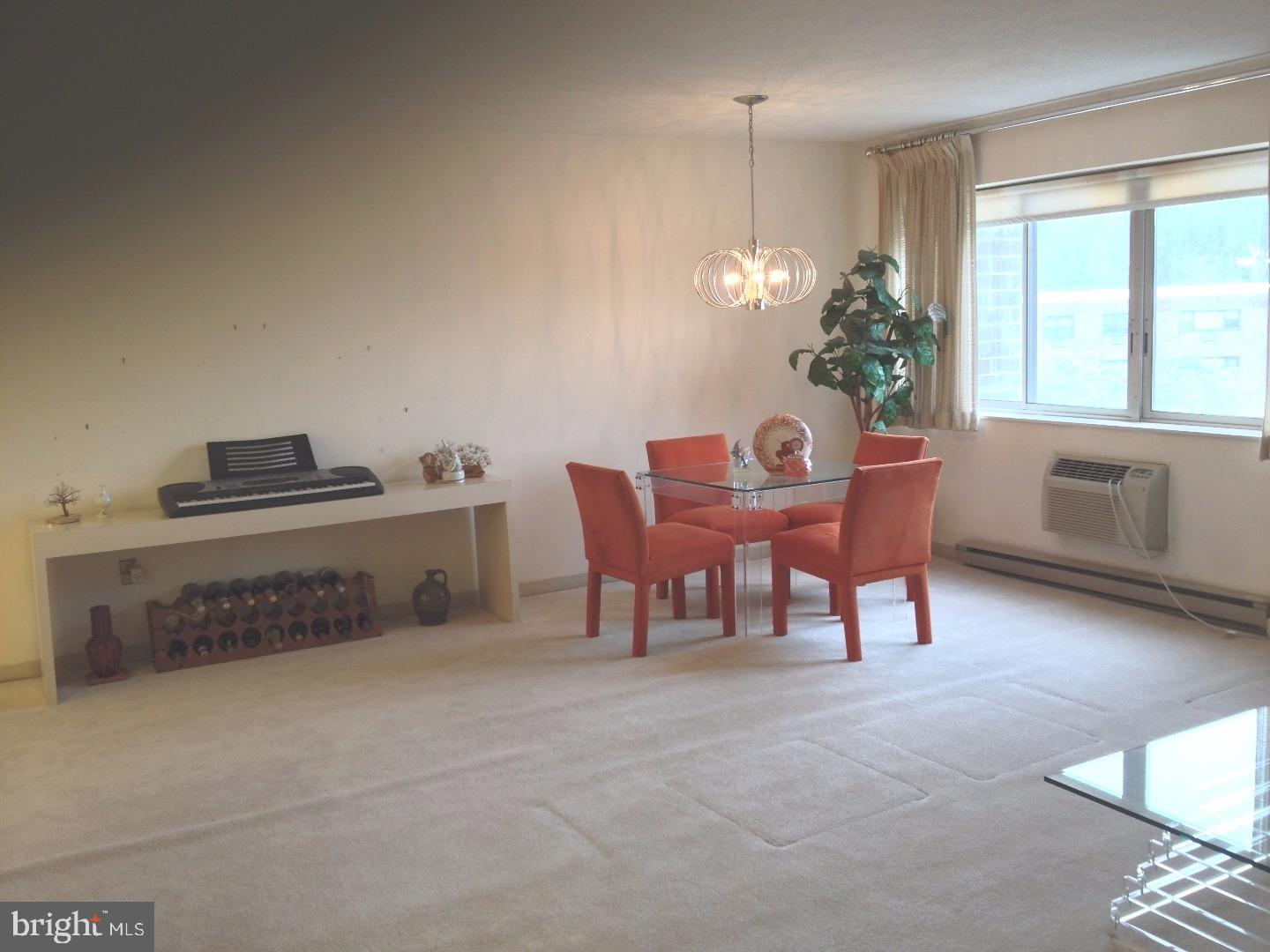 860 Lower Ferry Road, Unit 4F Ewing, NJ 08628 - Photo 9 of 18 a dining room with furniture and chandelier