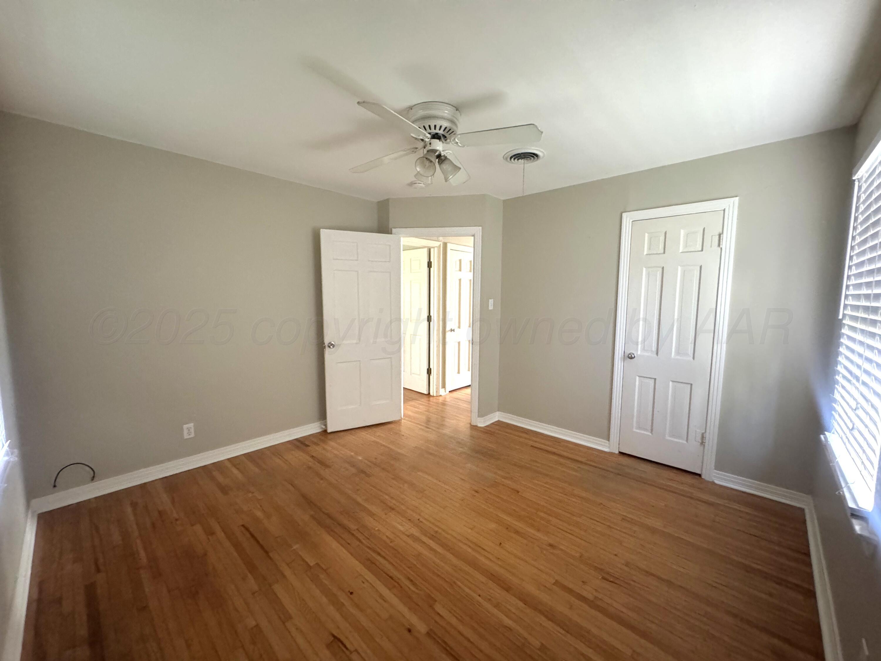 1222 South Bryan Street Amarillo, TX 79102 - Photo 13 of 18 wooden floor in an empty room with a window