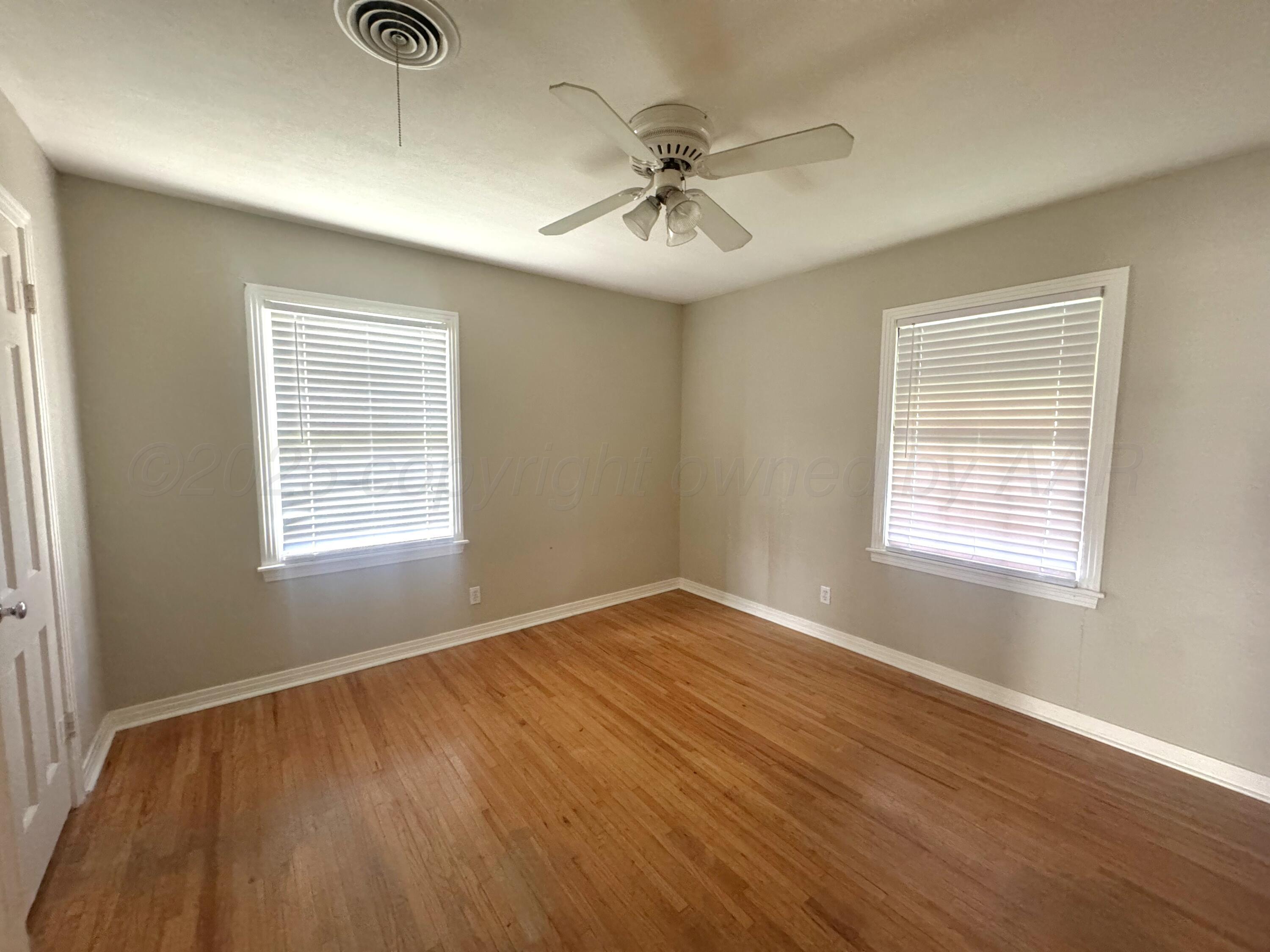 1222 South Bryan Street Amarillo, TX 79102 - Photo 16 of 18 a view of an empty room with wooden floor and a window