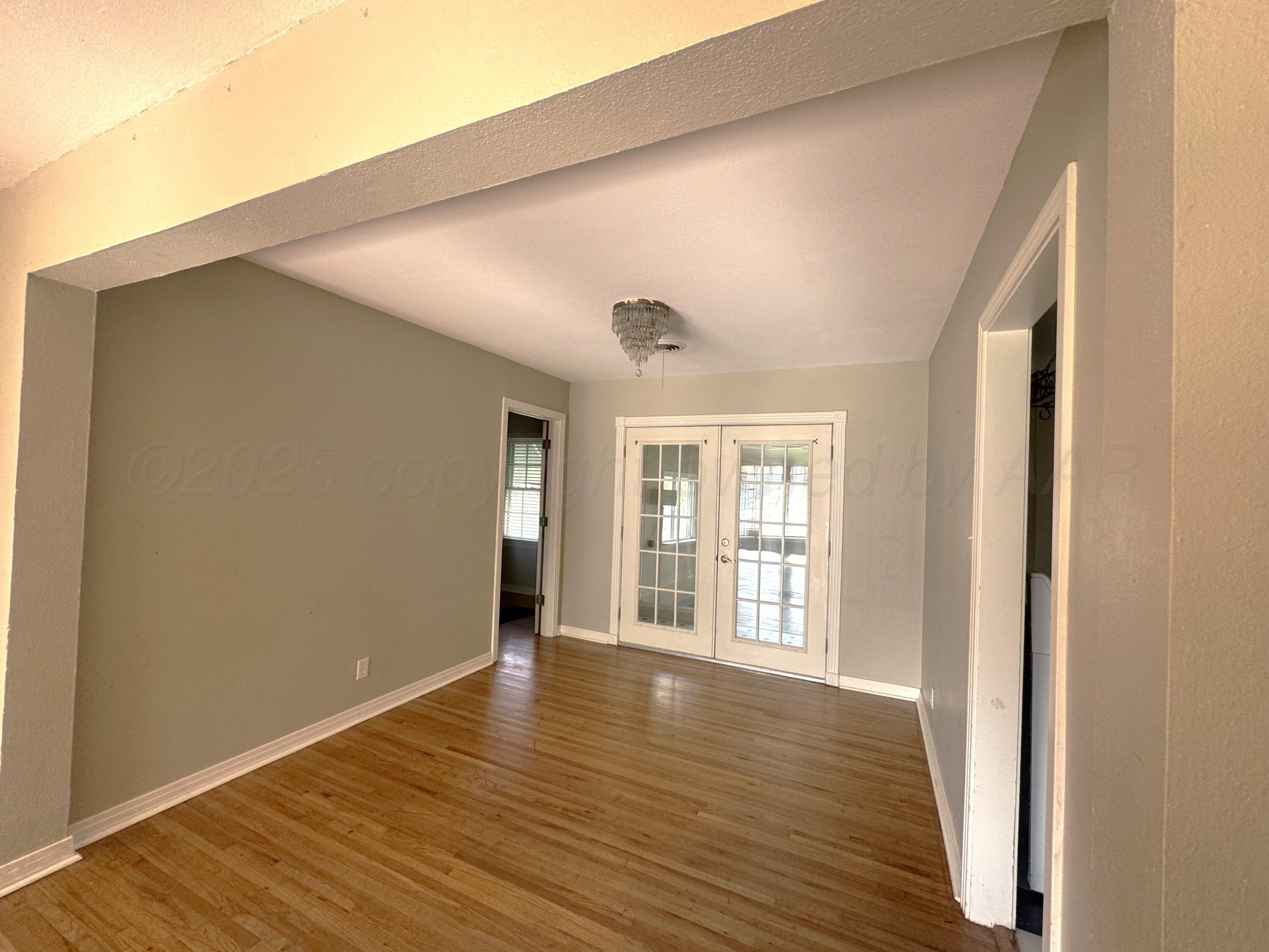 1222 South Bryan Street Amarillo, TX 79102 - Photo 5 of 18 an empty room with wooden floor and windows