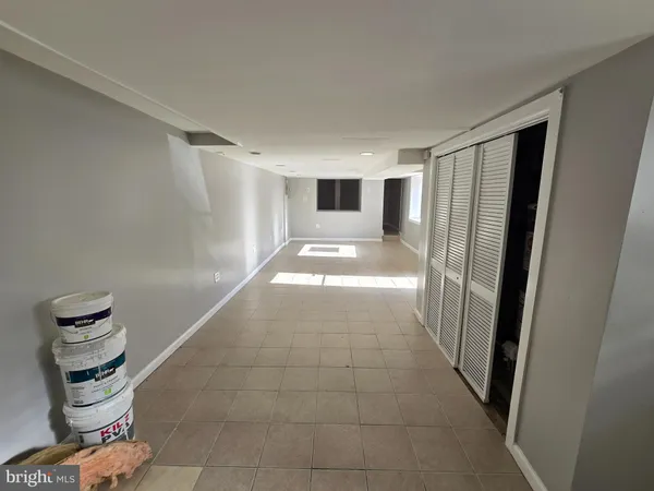a view of a hallway to a livingroom with furniture and stairs
