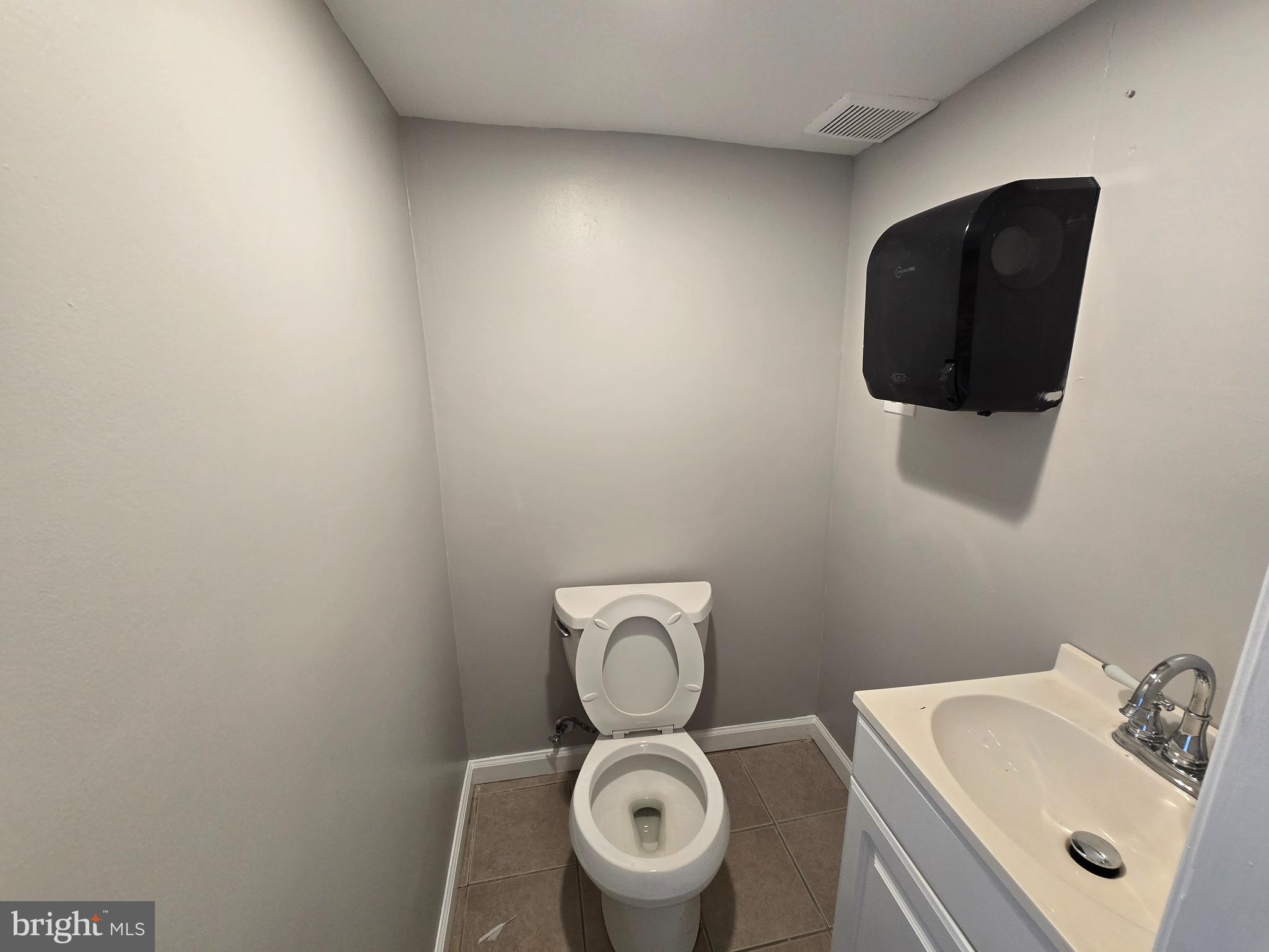 5901 Colgate Street Philadelphia, PA 19120 - Photo 10 of 10 a bathroom with a toilet sink and mirror