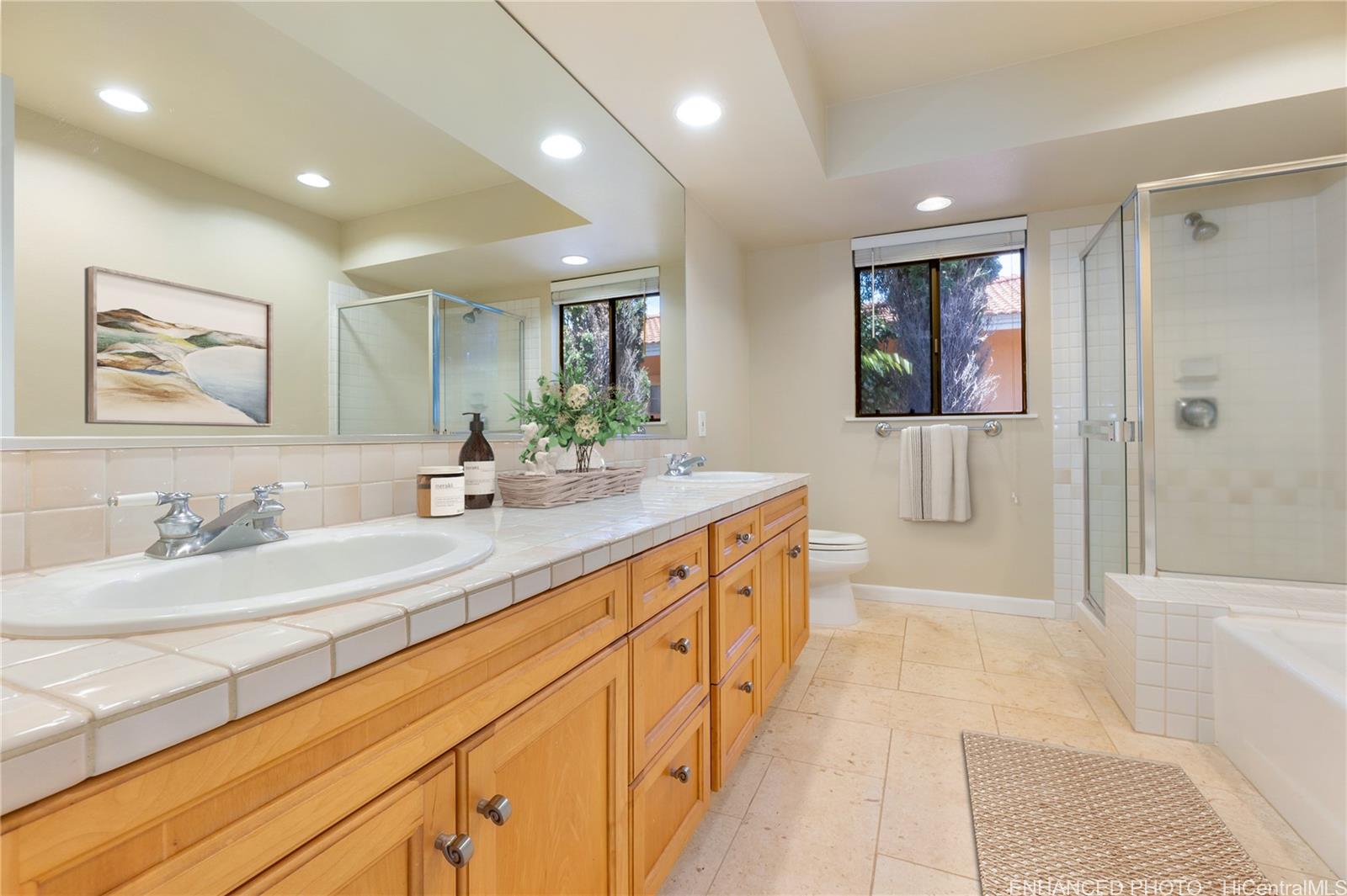 92-247 Opuakii Place Kapolei, HI 96707 - Photo 20 of 25 a spacious bathroom with double vanity a mirror and a shower