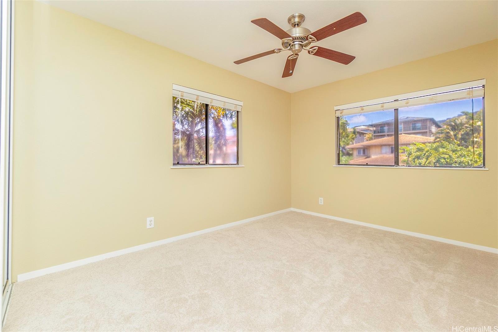 92-247 Opuakii Place Kapolei, HI 96707 - Photo 23 of 25 an empty room with a window and a ceiling fan