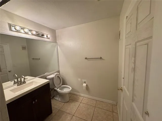 a bathroom with a double vanity sink toilet and a mirror