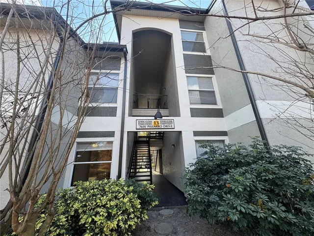 a front view of a building with a garden