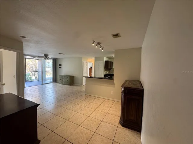 a view of a kitchen with a sink and a refrigerator