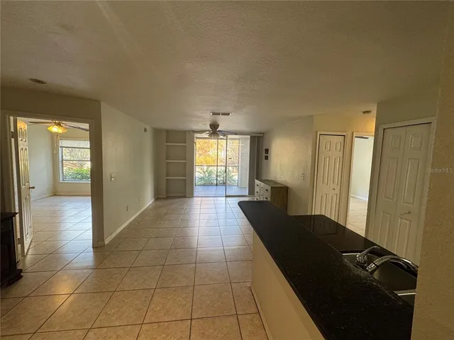 a view of a hallway with wooden floor and furniture