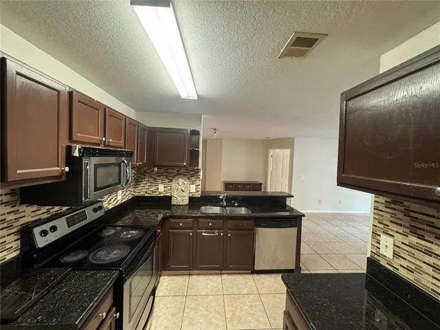 a kitchen with a sink appliances and cabinets