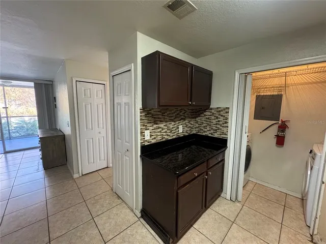 a kitchen with a stove refrigerator and microwave