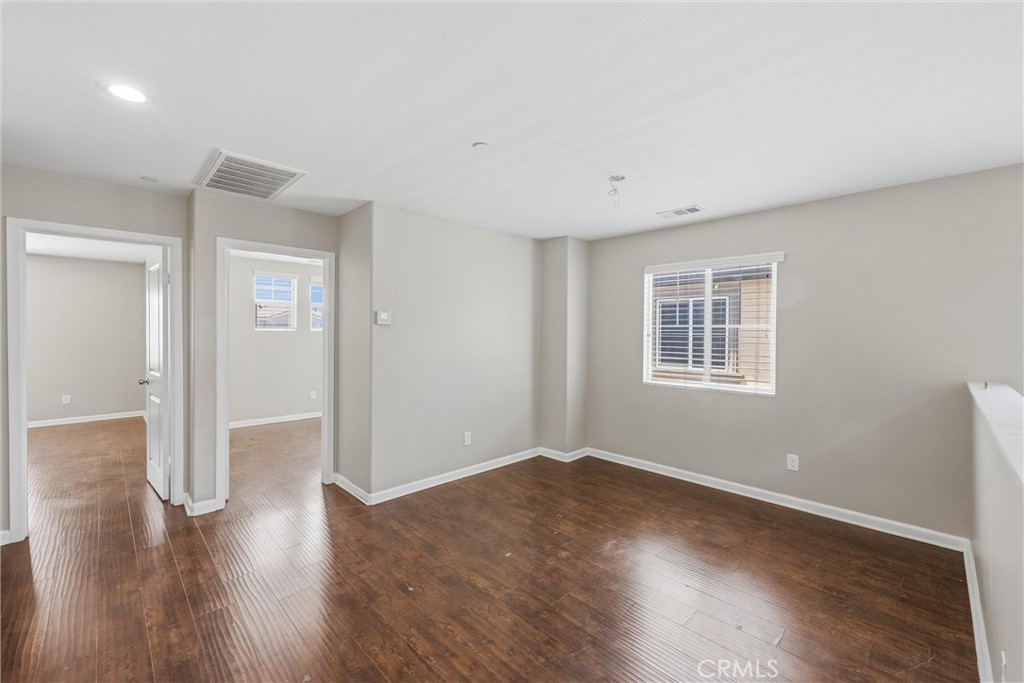 956 West Tibbot Street Rialto, CA 92377 - Photo 30 of 37 a view of a big room with wooden floor and windows