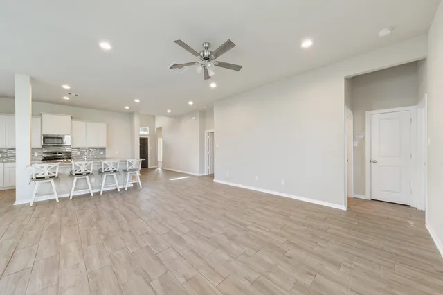 a view of kitchen with furniture and refrigerator