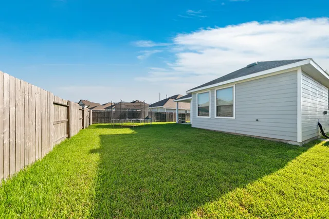a view of an house with backyard space and swimming pool